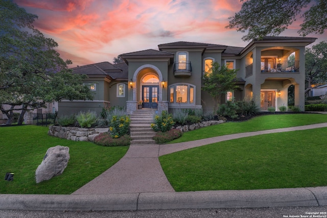 1015 Campanile, San Antonio, TX 78258 - mediterranean / spanish-style home featuring french doors, a balcony, stucco siding, and a front lawn