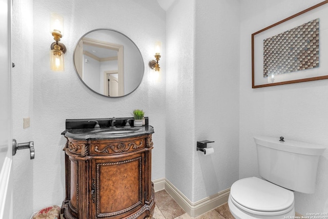 1015 Campanile, San Antonio, TX 78258 - bathroom with vanity, toilet, baseboards, a textured wall, and tile patterned floors