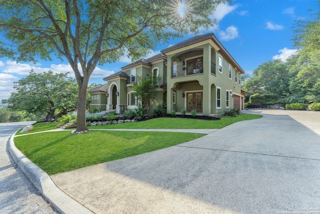 1015 Campanile, San Antonio, TX 78258 - mediterranean / spanish-style home featuring french doors, a balcony, concrete driveway, a front yard, and stucco siding