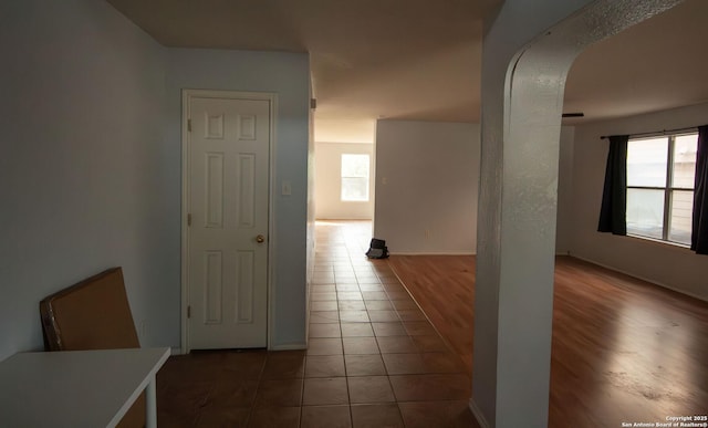7331 Obbligato Ln, San Antonio, TX 78266 - corridor with plenty of natural light, arched walkways, tile patterned flooring, and baseboards