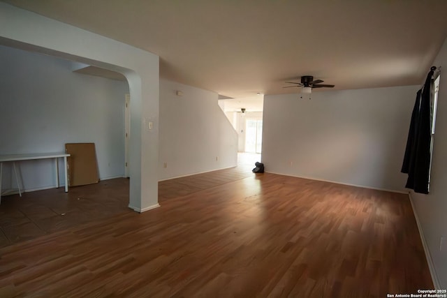 7331 Obbligato Ln, San Antonio, TX 78266 - empty room featuring a ceiling fan, wood finished floors, baseboards, and arched walkways