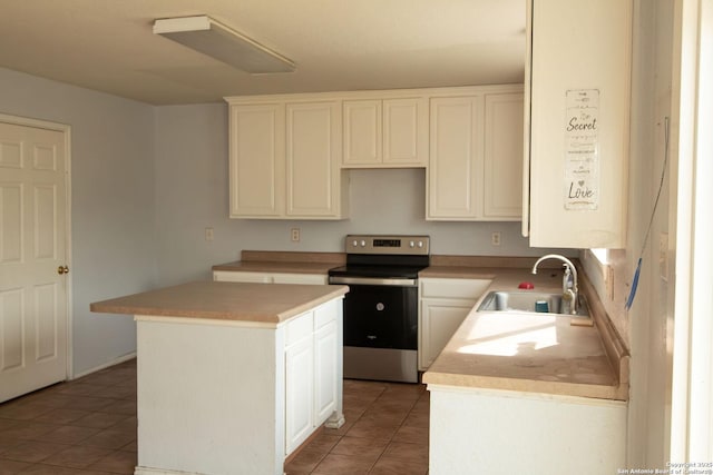 7331 Obbligato Ln, San Antonio, TX 78266 - kitchen featuring stainless steel range with electric cooktop, a sink, light tile patterned floors, a kitchen island, and light countertops