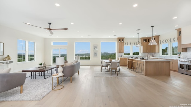 3140 Westview Dr, Canyon Lake, TX 78133 - living area featuring light wood finished floors, plenty of natural light, a ceiling fan, and recessed lighting