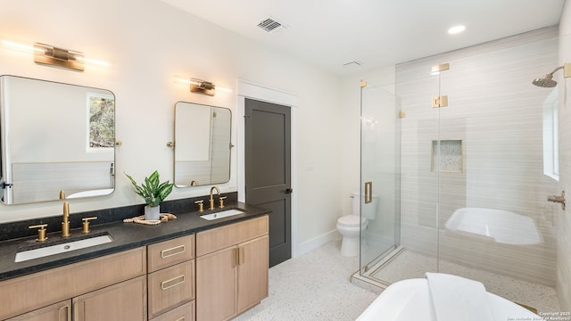 3140 Westview Dr, Canyon Lake, TX 78133 - bathroom featuring a shower stall, double vanity, a soaking tub, toilet, and recessed lighting