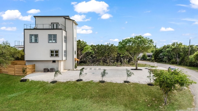 3140 Westview Dr, Canyon Lake, TX 78133 - back of property with a lawn, a balcony, and central air condition unit