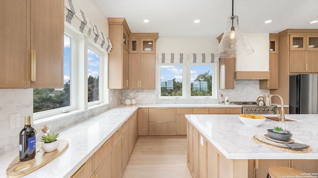 3140 Westview Dr, Canyon Lake, TX 78133 - kitchen featuring freestanding refrigerator, light stone countertops, decorative light fixtures, decorative backsplash, and glass insert cabinets