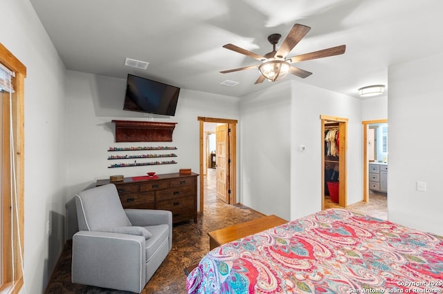 231 Doris Dr, Kerrville, TX 78028 - bedroom featuring a walk in closet, connected bathroom, a closet, and carpet flooring