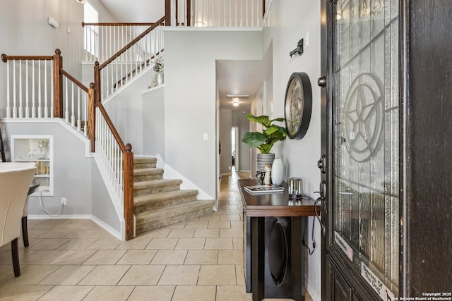 13508 Ashmont, Live Oak, TX 78233 - foyer featuring a towering ceiling, tile patterned flooring, stairs, and baseboards