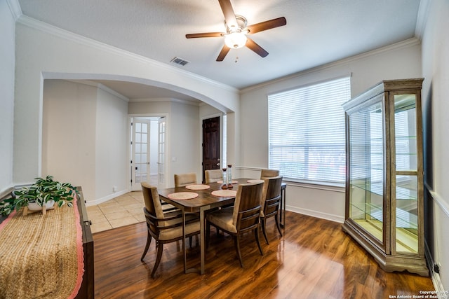 12406 Prince Solms, San Antonio, TX 78253 - dining area featuring arched walkways, ceiling fan, baseboards, wood finished floors, and crown molding