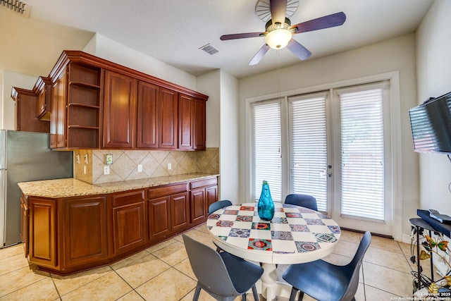 12406 Prince Solms, San Antonio, TX 78253 - kitchen featuring freestanding refrigerator, open shelves, backsplash, light tile patterned floors, and plenty of natural light