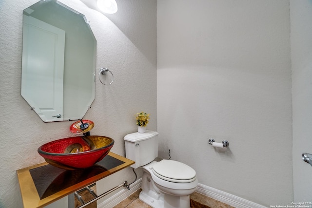 12406 Prince Solms, San Antonio, TX 78253 - half bath with toilet, baseboards, and a sink