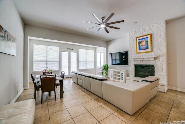 12406 Prince Solms, San Antonio, TX 78253 - living area with a ceiling fan, light tile patterned floors, french doors, a fireplace, and baseboards