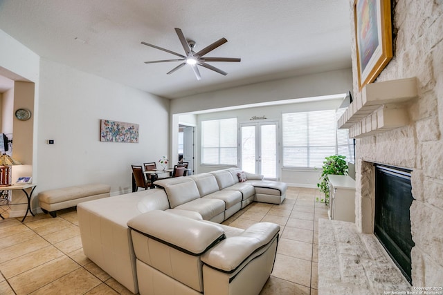 12406 Prince Solms, San Antonio, TX 78253 - living area with light tile patterned flooring, a ceiling fan, a stone fireplace, and french doors