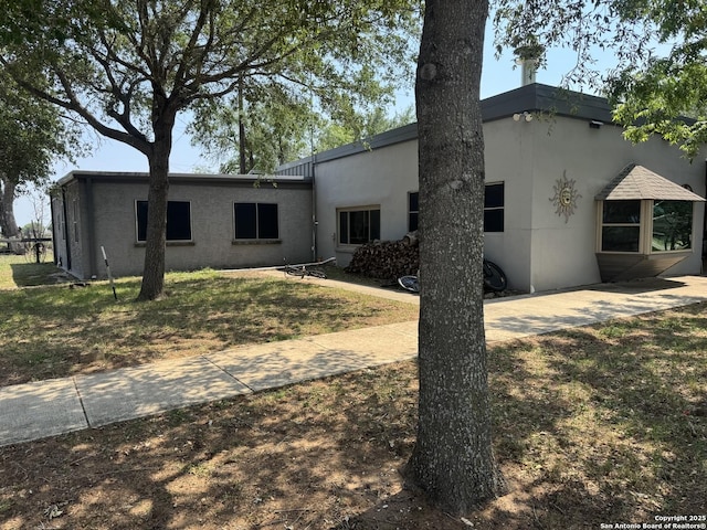 7084 Richter, Elmendorf, TX 78112 - rear view of house featuring stucco siding