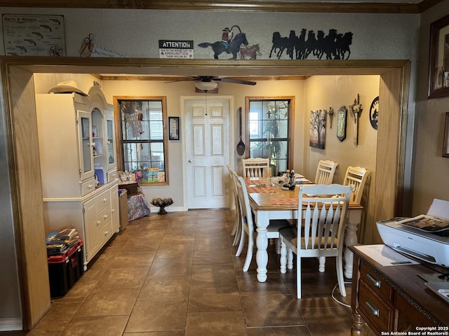 7084 Richter, Elmendorf, TX 78112 - dining area with a textured wall, dark tile patterned floors, and a ceiling fan