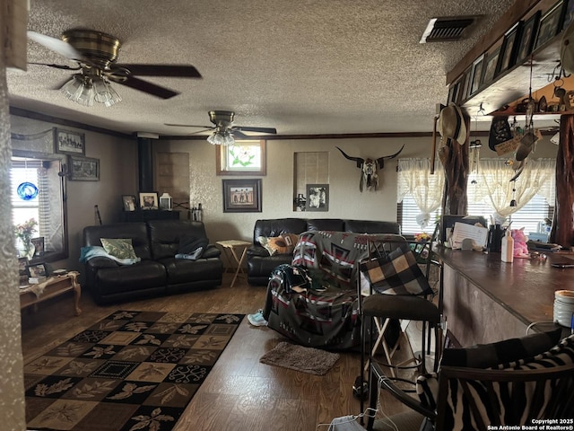7084 Richter, Elmendorf, TX 78112 - living room featuring hardwood / wood-style flooring, a textured ceiling, and ceiling fan