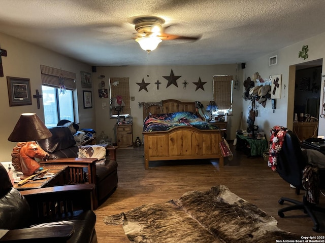 7084 Richter, Elmendorf, TX 78112 - bedroom featuring wood finished floors, a textured ceiling, and ceiling fan
