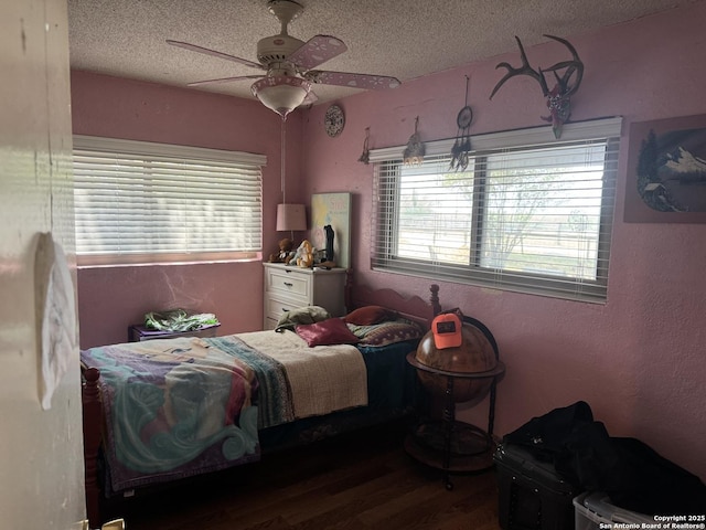 7084 Richter, Elmendorf, TX 78112 - bedroom with a textured ceiling, wood finished floors, multiple windows, and ceiling fan