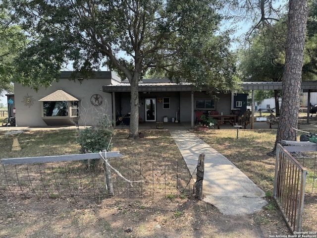 7084 Richter, Elmendorf, TX 78112 - view of front facade with stucco siding and a porch