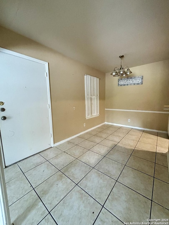 170 De Chantle Rd Unit 205, San Antonio, TX 78201 - unfurnished dining area with light tile patterned flooring, a chandelier, and baseboards