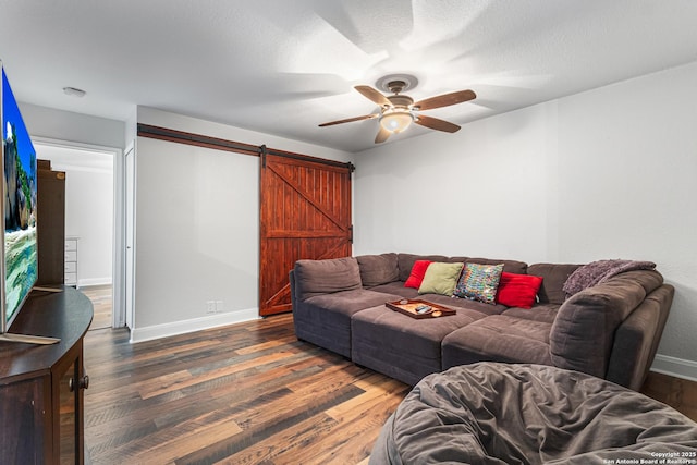 1946 Encino Belle, San Antonio, TX 78259 - living area featuring a barn door, a ceiling fan, wood finished floors, and baseboards