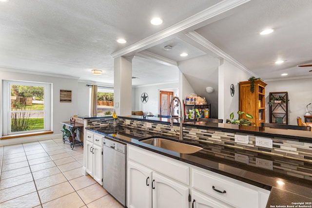 1946 Encino Belle, San Antonio, TX 78259 - kitchen featuring a sink, stainless steel dishwasher, dark countertops, crown molding, and white cabinets