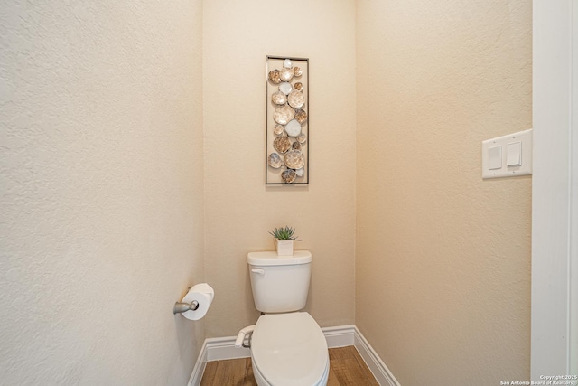 12827 Sabinal Riv, San Antonio, TX 78253 - bathroom with baseboards, toilet, and wood finished floors