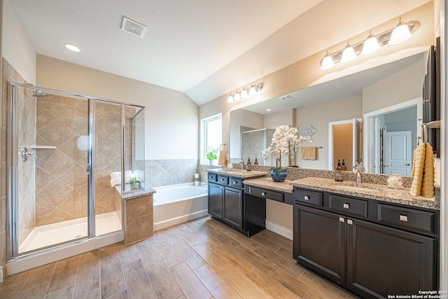 12827 Sabinal Riv, San Antonio, TX 78253 - full bath with vanity, a garden tub, a stall shower, wood finished floors, and vaulted ceiling