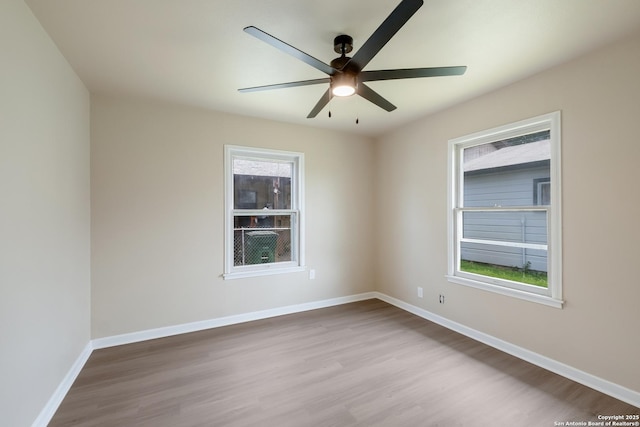 142 W Palfrey, San Antonio, TX 78223 - unfurnished room featuring wood finished floors, plenty of natural light, and a ceiling fan