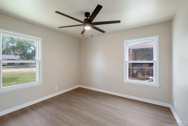 142 W Palfrey, San Antonio, TX 78223 - empty room with wood finished floors, ceiling fan, and baseboards