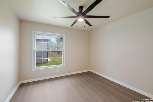 142 W Palfrey, San Antonio, TX 78223 - unfurnished room with wood finished floors, a ceiling fan, and baseboards
