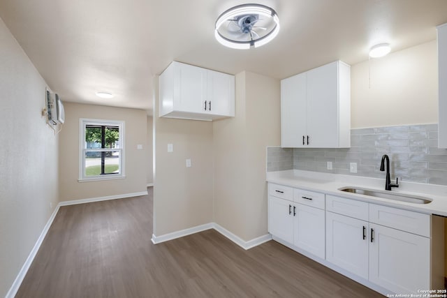 142 W Palfrey, San Antonio, TX 78223 - kitchen with a sink, wood finished floors, backsplash, and light countertops