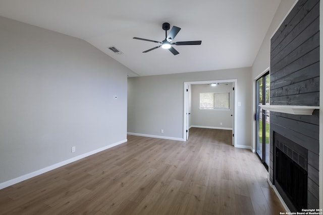 6723 Hickory Springs Dr, San Antonio, TX 78249 - unfurnished living room featuring a fireplace, vaulted ceiling, wood finished floors, ceiling fan, and baseboards