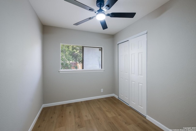6723 Hickory Springs Dr, San Antonio, TX 78249 - unfurnished bedroom with wood finished floors, baseboards, a closet, and ceiling fan