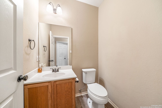 20519 View Mdw, San Antonio, TX 78258 - bathroom with vanity, toilet, wood finished floors, and baseboards