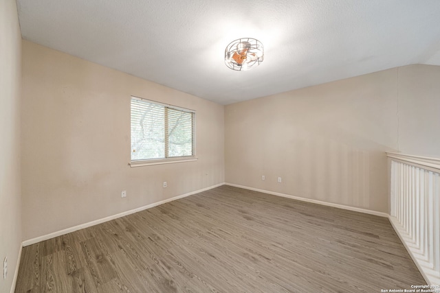 20519 View Mdw, San Antonio, TX 78258 - empty room with wood finished floors, baseboards, and lofted ceiling