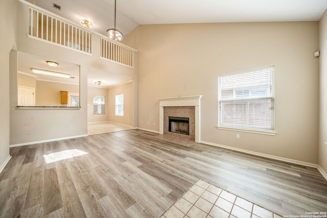 20519 View Mdw, San Antonio, TX 78258 - unfurnished living room featuring high vaulted ceiling, wood finished floors, baseboards, and a fireplace