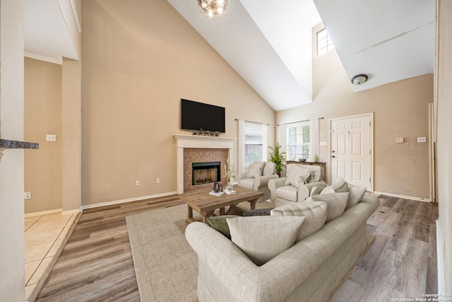 20519 View Mdw, San Antonio, TX 78258 - living area with high vaulted ceiling, a fireplace, baseboards, a skylight, and wood finished floors