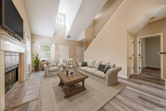20519 View Mdw, San Antonio, TX 78258 - living area with high vaulted ceiling, wood finished floors, baseboards, and a tiled fireplace