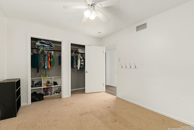 402 Teakwood, Victoria, TX 77901 - bedroom featuring carpet, two closets, baseboards, and a ceiling fan