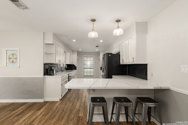 402 Teakwood, Victoria, TX 77901 - kitchen with a sink, open shelves, white cabinetry, a peninsula, and stainless steel fridge with ice dispenser