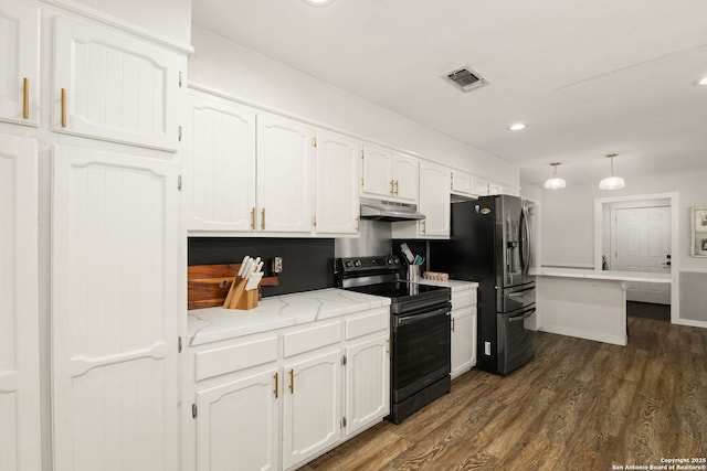 402 Teakwood, Victoria, TX 77901 - kitchen with appliances with stainless steel finishes, under cabinet range hood, white cabinets, dark wood-style flooring, and recessed lighting