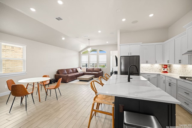529 Huntwick, Boerne, TX 78006 - kitchen featuring appliances with stainless steel finishes, a sink, a ceiling fan, tasteful backsplash, and light wood-style floors