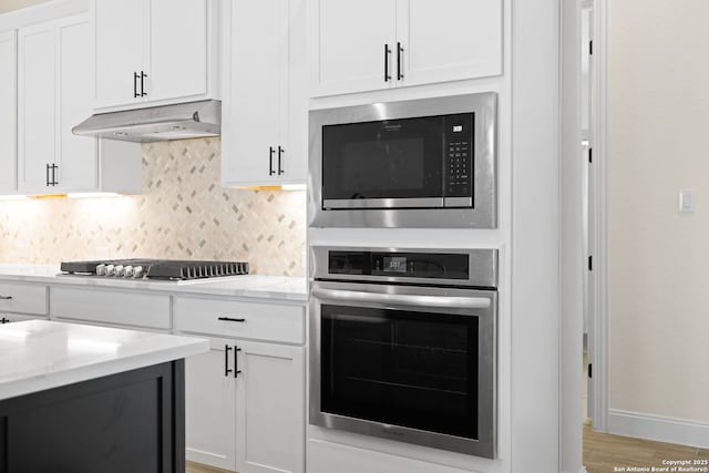 529 Huntwick, Boerne, TX 78006 - kitchen featuring stainless steel appliances, backsplash, and white cabinetry
