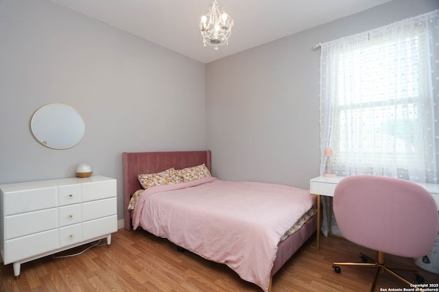 8955 Highland Dawn, San Antonio, TX 78254 - bedroom featuring wood finished floors and a chandelier