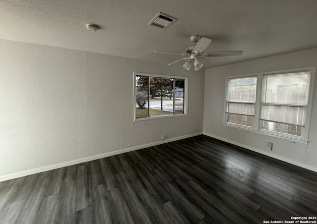 102 Killarney Dr, San Antonio, TX 78223 - unfurnished room featuring dark wood-type flooring, baseboards, a ceiling fan, and a textured ceiling