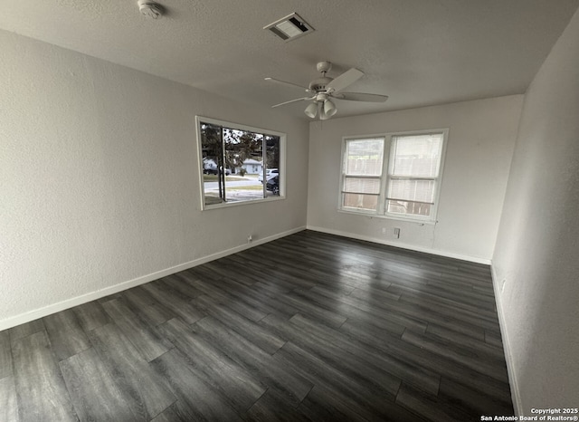 102 Killarney Dr, San Antonio, TX 78223 - spare room featuring ceiling fan, baseboards, dark wood-type flooring, and a smoke detector