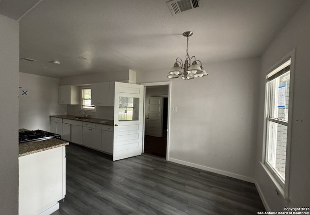 102 Killarney Dr, San Antonio, TX 78223 - kitchen with white cabinets, dark wood-style flooring, a sink, and a chandelier