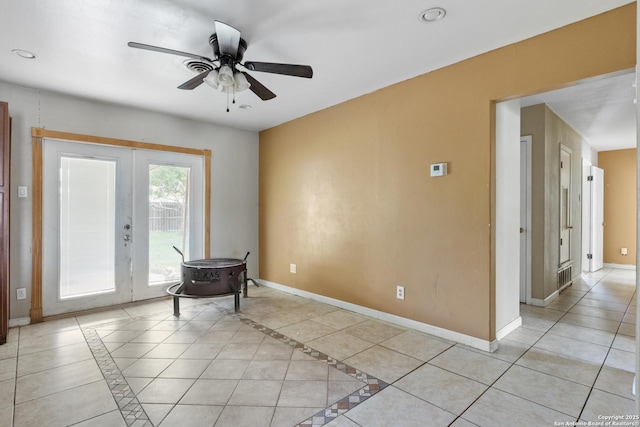 4503 Tropical, San Antonio, TX 78218 - unfurnished room featuring ceiling fan, french doors, baseboards, recessed lighting, and a wood stove