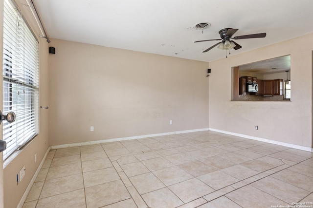 4503 Tropical, San Antonio, TX 78218 - unfurnished room with a ceiling fan, light tile patterned floors, and baseboards